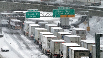 In this Jan. 11, 2017, file photo, early morning traffic is at a standstill on Interstate 5 headed into town as a semi truck and cars block the off ramp to Highway 217 above in Portland, Ore. A federal watchdog says the Trump administration moved to exempt a type of super-polluting cargo truck from clean air rules without conducting a federally mandated study on how it would impact public health.