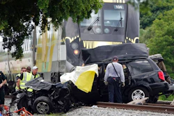 In this Aug 25, 2019 file photo, Broward Sheriff's Deputies and Pompano Beach Fire Rescue work the scene of a fatal accident on North Dixie Highway in Pompano Beach, Fla. The Florida higher-speed passenger train service tied to Richard Branson’s Virgin Group has the worst per-mile death rate in the U.S. The first death involving a Brightline train happened in July 2017 during test runs. An Associated Press analysis of Federal Railroad Administration data shows that since then, 40 more have been killed. That amounts to a rate of more than one a month and about one for every 29,000 miles (47,000 kilometers) the trains have traveled since the first death.