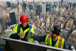 In this March 8, 2019, file photo, work continues on an outdoor observation deck on the 30 Hudson Yards office building in New York. Business economists expect U.S. economic growth to slow this year and next, but they say the economy will avoid recession.