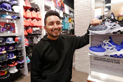 Victor Duran, a co-manager of a sports apparel store at the Southcenter mall, south of Seattle, poses for a photo at the store, Wednesday, Dec. 11, 2019, in Tukwila, Wash. Duran, 23, said he makes about $52,000 a year and doesn't get overtime, but is required to work at least 45 hours per week, and up to 60 during the holidays. Duran is one employee who could benefit from new overtime rules in Washington state, which will allow hundreds of thousands of workers who have been exempt to begin collecting when they work more than 40 hours per week.