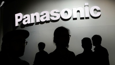 -In this Jan. 9, 2018, file photo, people walk by the Panasonic booth during CES International in Las Vegas. Japanese electronics manufacturer Panasonic Corp. is abandoning the semiconductor business with the sale of its last business in that sector to a Taiwanese company. Panasonic said Thursday it was transferring the semiconductor business operated by Panasonic Semiconductor Solutions Co. to Nuvoton Technology Corp.