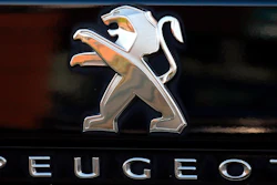 In this Oct. 31, 2019, file photo, a Peugeot logo pictured on a car in Bayonne, southwestern France. Fiat Chrysler Automobiles and PSA Peugeot announced Wednesday, Dec. 18, 2019, that their boards signed a binding deal to merge the two automakers, creating the world’s fourth-largest auto company.