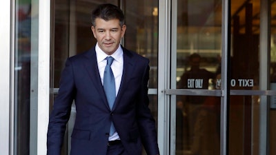 In this Feb. 7, 2018, file photo, former Uber CEO Travis Kalanick leaves federal court in San Francisco. Former Uber CEO Kalanick will resign from the company's board next week, effectively severing ties with the company he co-founded a decade ago.