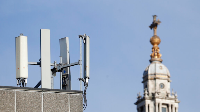 Mobile network phone masts are visible in front of St Paul's Cathedral in the City of London, Tuesday, Jan. 28, 2020.The Chinese tech firm Huawei has been designated a 'high-risk vendor' but will be given the opportunity to build non-core elements of Britain's 5G network, the government has announced. The company will be banned from the 'core', of the 5G network, and from operating at sensitive sites such as nuclear and military facilities, and its share of the market will be capped at 35%.