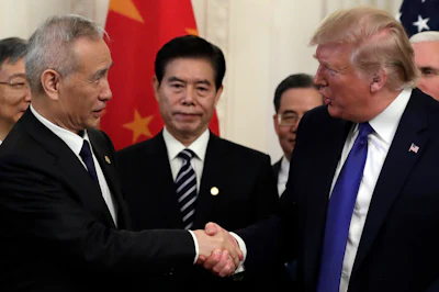 President Donald Trump shakes hands with Chinese Vice Premier Liu He after signing a trade agreement in the East Room of the White House on Wednesday, Jan. 15, in Washington.