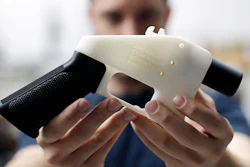 In this Aug. 1, 2018 file photo, Cody Wilson, with Defense Distributed, holds a 3D-printed gun called the Liberator at his shop in Austin, TX.