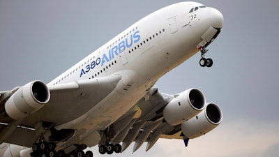In this June 18, 2015, file photo, an Airbus A380 takes off for its demonstration flight at the Paris Air Show in Le Bourget airport, north of Paris. Airbus says it has reached potential settlement agreements with financial investigators in the U.S., Britain and France. British and French authorities are investigating alleged fraud and bribery related to Airbus' use of outside consultants to sell planes.