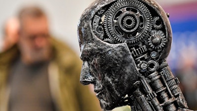In this Nov. 29, 2019, file photo, a metal head made of motor parts symbolizes artificial intelligence, or AI, at the Essen Motor Show for tuning and motorsports in Essen, Germany. The Trump administration is proposing new rules guiding how the U.S. government regulates the use of artificial intelligence in medicine, transportation and other industries. The White House unveiled the proposals Tuesday, Jan. 7, and said they're meant to promote private sector applications of AI that are safe and fair.
