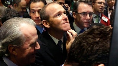 n this Jan. 26, 2011 file photo, Nielsen Company CEO David Calhoun, center, watches progress as he waits for the company's IPO to begin trading, on the floor of the New York Stock Exchange. Calhoun took over Monday, Jan. 13, 2020, as Boeing's third CEO in the last five years, following the firing last month of Dennis Muilenburg.
