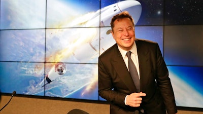 In this Jan. 19, 2020, file photo Elon Musk, founder, CEO, and chief engineer/designer of SpaceX speaks during a news conference at the Kennedy Space Center in Cape Canaveral, Fla. The meteoric rise of Tesla shares that pushed the company's value over $100 billion could turn into a supercharged payday for CEO Elon Musk.