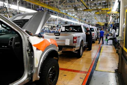 In this Sept. 27, 2018, file photo a United Auto Workers assemblyman works on a 2018 Ford F-150 truck being assembled at the Ford Rouge assembly plant in Dearborn, Mich. Ford is recalling its popular F-150 pickup truck in Canada to fix a problem with electric tailgate latches, but identical trucks aren't being recalled in the U.S.