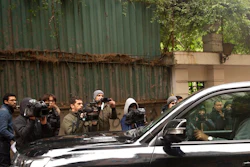 Journalists film a vehicle leaving the house of ex-Nissan chief Carlos Ghosn in Beirut, Lebanon, Friday, Jan. 3, 2020. The former Nissan Motor Co. Chairman fled Japan this week while awaiting trial on financial misconduct charges and appeared in Lebanon.