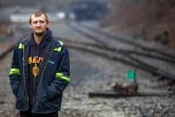 In this Tuesday, Jan. 14, 2020 photo, Timmy George, an employee of Quest Energy, stands on railroad tracks where miners, who say they haven't been paid in nearly three weeks, block a coal train in the Kimper area of Pike County, Ky.