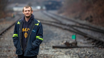 In this Tuesday, Jan. 14, 2020 photo, Timmy George, an employee of Quest Energy, stands on railroad tracks where miners, who say they haven't been paid in nearly three weeks, block a coal train in the Kimper area of Pike County, Ky.