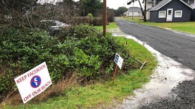 sign expressing opposition to a plan by Facebook to build a landing spot for a submarine cable connecting America with Asia stands on property in the tiny community of Tierra del Mar, Ore., Wednesday, Jan. 8, 2020.