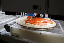 Picnic's pizza-making robot makes a pizza at a food vendor's booth during the CES tech show, Wednesday, Jan. 8, 2020, in Las Vegas.