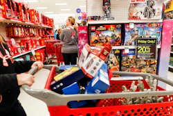 In this Nov. 23, 2018, file photo shoppers browse the aisles during a Black Friday sale at a Target store in Newport, Ky. Comparable stores sales at Target fell well below the previous year, joining a growing list of retailers reporting a meager performances during the critical holiday shopping season. Target said Wednesday, Jan. 15, 2020, that it had weaker-than-expected sales of electronics, toys and some home good. Those sales climbed 1.4% in the November-December period, compared with a 5.7% increase a year earlier.
