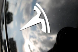 In this July 8, 2018, file photo, clouds are reflected above the company logo on the hood of a Tesla vehicle outside a showroom in Littleton, Colo. The National Highway Traffic Safety Administration is investigating the crash of a speeding Tesla that killed two people in a Los Angeles suburb, the agency announced Tuesday, Dec. 31, 2019.