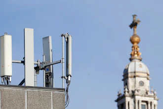 Mobile network phone masts are visible in front of St Paul's Cathedral in the City of London, Tuesday, Jan. 28, 2020.The Chinese tech firm Huawei has been designated a 'high-risk vendor' but will be given the opportunity to build non-core elements of Britain's 5G network, the government has announced. The company will be banned from the 'core', of the 5G network, and from operating at sensitive sites such as nuclear and military facilities, and its share of the market will be capped at 35%.