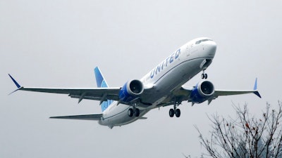 In this Dec. 11, 2019, file photo, an United Airlines Boeing 737 Max airplane takes off in the rain at Renton Municipal Airport in Renton, Wash. Boeing said Tuesday, Jan, 7, 2020, it is recommending that pilots receive training in a flight simulator before the grounded 737 Max returns to flying, a reversal of the company's long-held position that computer-based training alone was adequate. The 737 Max has been grounded worldwide since last March after two crashes killed 346 people.