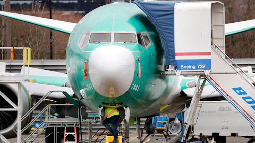 In this Dec. 16, 2019, file photo a worker looks up underneath a Boeing 737 MAX jet in Renton, Wash. Boeing sold no new airline jets in January, and now the company is worried that the virus outbreak in China could hurt airplane deliveries in the first quarter.