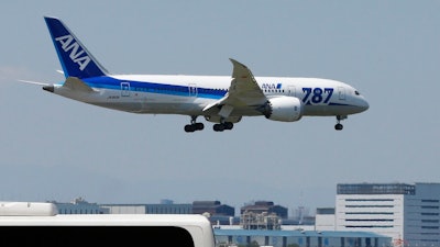 In this Sunday, April 28, 2013 file photo, a Boeing 787 plane of the All Nippon Airways, ANA, prepares to land after a test flight at Haneda Airport in Tokyo. Japanese carrier ANA is ordering 20 Boeing 787 Dreamliner jets, bringing its fleet of the planes to 103 by 2025.