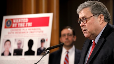 Attorney General William Barr speaks during a news conference, Monday, Feb. 10, 2020, at the Justice Department in Washington, as Principal Associate Deputy Attorney General Seth Ducharm looks on.