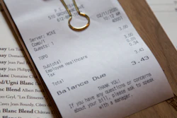 In this Feb. 11 photo, a line item shows an example of how the charge that Brent Frederick, founder of Jester Concepts, a restaurant group in Minneapolis uses as a 3% voluntary surcharge on guest checks to help pay for health insurance and mental health services and says almost all guests agree to pay it.