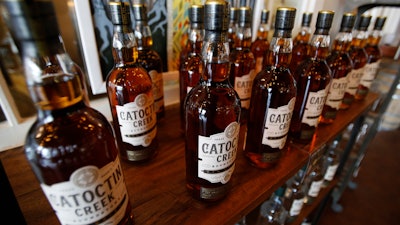 In this June 20, 2018 file photo, Catoctin Creek Distillery whiskey is on display in a tasting room in Purcellville, VA. A new spirits industry report says President Donald Trump's trade war dampened the overseas market for American-made whiskey last year. The Distilled Spirits Council says overall exports of bourbon, Tennessee whiskey and rye whiskey tumbled amid a trade war-induced decline in exports to key European markets.