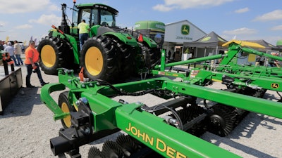 In this Sept. 10, 2019, file photo a John Deere tractor is on display at the Husker Harvest Days farm show in Grand Island, Neb. Deere & Co. reports earns on Thursday, Feb. 20, 2020.