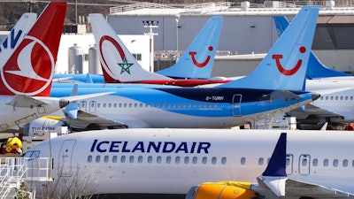 Grounded Boeing 737 MAX airplanes fill a parking area adjacent to Boeing Field, Wednesday, Feb. 19, 2020, in Seattle. Washington state lawmakers say they will introduce bills, at The Boeing Co.'s request, to suspend the aerospace giant's preferential business and occupation tax rate until the United States and European Union resolve their long-running international trade dispute.