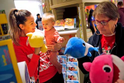 In this Dec. 9, 2019, file photo Melissa Rogan, left, and her daughter Renee, 9-months-old, browse the new Toys R Us store at a mall in Paramus, N.J. On Tuesday, Feb. 25, 2020, the Conference Board reports on U.S. consumer confidence for February.