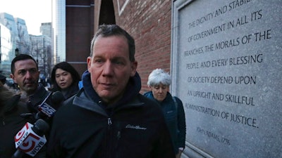 Harvard University professor Charles Lieber leaves the Moakley Federal Courthouse with his wife Jennifer, right, in Boston, Thursday, Jan. 30, 2020. Leiber, chair of the department of chemistry and chemical biology, with lying to officials about his involvement with a Chinese government-run recruitment program through which he received tens of thousands of dollars.