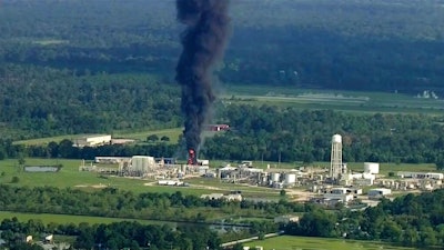 In this Sept. 1, 2017, file photo, smoke rises from the Arkema Inc. owned chemical plant in Crosby, near Houston, Texas. In February 2020, the Pennsylvania-based company, which is a subsidiary of a French chemical manufacturer, and three of its executives are set to stand trial in Houston in a case that legal experts say will be a challenge for prosecutors to win.