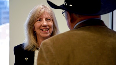 Former Interior Secretary Gale Norton mingles after a news conference in Denver on Monday, Feb. 10, 2020, a day before the Trump administration hosts the first of two hearings on a proposal to roll back a landmark environmental law.