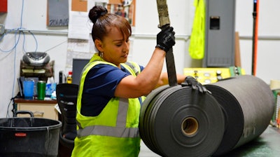 In this May 25, 2018 file photo, an employee at Acme Mills in Santa Teresa, N.M., works to organize textiles. Border trade leaders are expressing optimism for the 2020 trade forecast with Mexico, especially at the busy Santa Teresa Port of Entry in New Mexico, following the new free trade agreement.