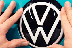 A worker completes an electric car ID.3 body at the assembly line during a press tour at the plant of the German manufacturer Volkswagen AG (VW) in Zwickau, eastern Germany, Tuesday, Feb. 25, 2020.