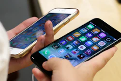 In this Sept. 16, 2016 file photo, a customer compares her iPhone 6, left, with an iPhone 7 at an Apple Store in Chicago.