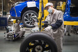 In this photo released by Xinhua News Agency, workers labor at an assembly line for Dongfeng Passenger Vehicle Company in Wuhan, in central China's Hubei Province, March 24, 2020.