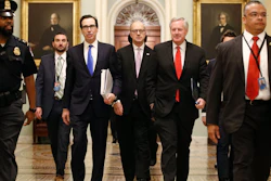 Treasury Secretary Steven Mnuchin, left, accompanied by White House Legislative Affairs Director Eric Ueland and acting White House chief of staff Mark Meadows, walks to the offices of Senate Majority Leader Mitch McConnell on Capitol Hill in Washington on Tuesday, March 24.