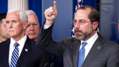 Health and Human Services Secretary Alex Azar speaks, with Vice President Mike Pence behind him, during a briefing about the coronavirus in the James Brady Press Briefing Room of the White House, Sunday, March 15, 2020, in Washington.