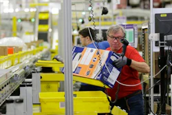 A worker sorts products in an Amazon fulfillment center.