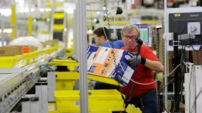 A worker sorts products in an Amazon fulfillment center.
