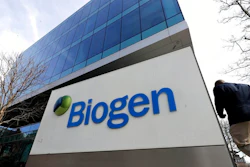 A man walks outside the Biogen Inc., headquarters, Wednesday, March 11, 2020, in Cambridge, Mass. Seventy of Massachusetts' first 92 confirmed coronavirus cases have been linked to a meeting of Biogen executives that was held at the Marriott Long Wharf hotel in Boston in late February 2020. For most people, the virus causes only mild or moderate symptoms, such as fever and cough. For some, especially older adults and people with existing health problems, it can cause more severe illness, including pneumonia. The vast majority of people recover from the new virus.