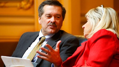 Del. Terry Kilgore R-Scott, left, talks with Del. Kathy Byron, R-Bedford, during the House session at the Capitol Friday, Feb. 28, 2020, in Richmond, Va. Legislators from southwest Virginia have mounted a huge push to oppose the possible early closure of one of the country's newest coal plants.