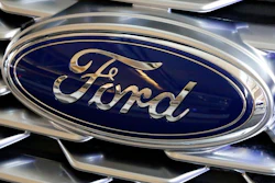 This Feb. 15, 2018 photo shows a Ford logo on display at the Pittsburgh Auto Show in Pittsburgh. Ford is recalling more than 268,000 cars in North America, on Wednesday, March 25, 2020 to fix doors that could open unexpectedly or may not close. The recall covers the 2014 through 2016 Ford Fusion and Lincoln MKZ, and the 2014 and 2015 Ford Fiesta.