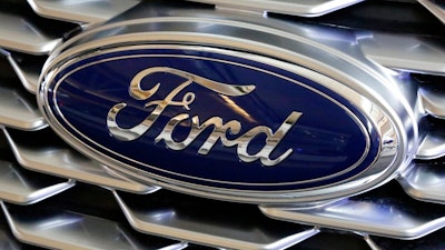 This Feb. 15, 2018 photo shows a Ford logo on display at the Pittsburgh Auto Show in Pittsburgh. Ford is recalling more than 268,000 cars in North America, on Wednesday, March 25, 2020 to fix doors that could open unexpectedly or may not close. The recall covers the 2014 through 2016 Ford Fusion and Lincoln MKZ, and the 2014 and 2015 Ford Fiesta.