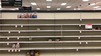 Shelves usually stocked with bread lay nearly empty at a Target in Abington, PA on Wednesday, March 18.