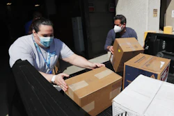 Christina Caldwell, left, of Henry Ford Population Health helps unload supplies with Matt Thatcher, who donated them from the Detroit Golf Club, Wednesday, April 8, 2020, in Detroit.