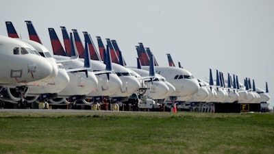 Several dozen mothballed Delta Air Lines jets are parked at Kansas City International Airport in Kansas City, Mo.